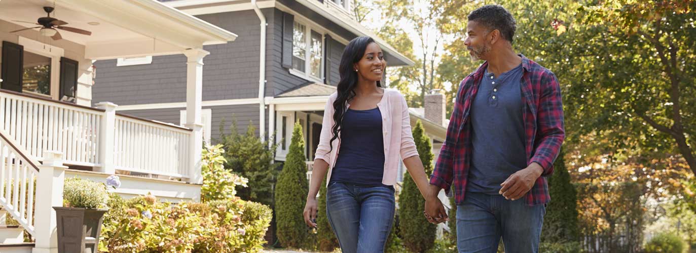 Couple walking along a suburban street